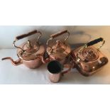 Three copper kettles and a copper tankard.