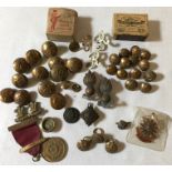 Military brass buttons and cap badges.