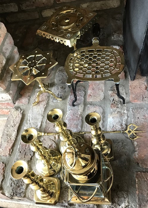 Brass ware including kettle stands, candlesticks, toasting fork and lamp.