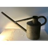 A vintage galvanised metal watering can.