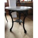 A marble topped cast iron table. 70cms d.