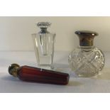 Three glass scent bottles including one with silver top (dint to lid) and one 19thC ruby glass