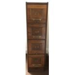 Oak four height filing cabinet. 143cms h, 29cms w, 69cms d.