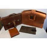 Two leather briefcases and two leather writing cases.