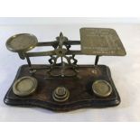 Set of brass postal scales with weights.