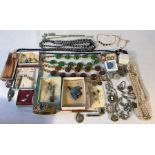 A quantity of costume jewellery including glass bead necklaces, brooches, earrings etc.