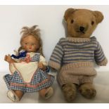Small vintage pottery doll together with well loved straw filled teddy bear, 33cms.