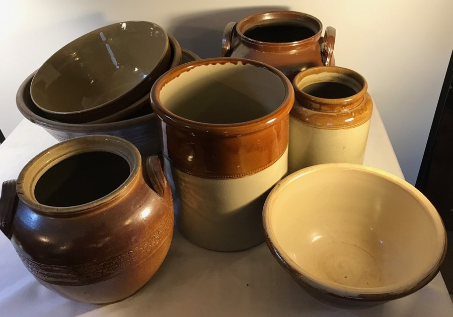 Eight various brown glazed earthenware pots.