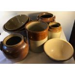 Eight various brown glazed earthenware pots.