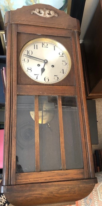 An oak cased wall clock.