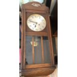 An oak cased wall clock.