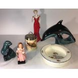 Six pieces of various ceramics including Royal Doulton ‘Little Nell’, Poole Otter, Poole Dolphin,