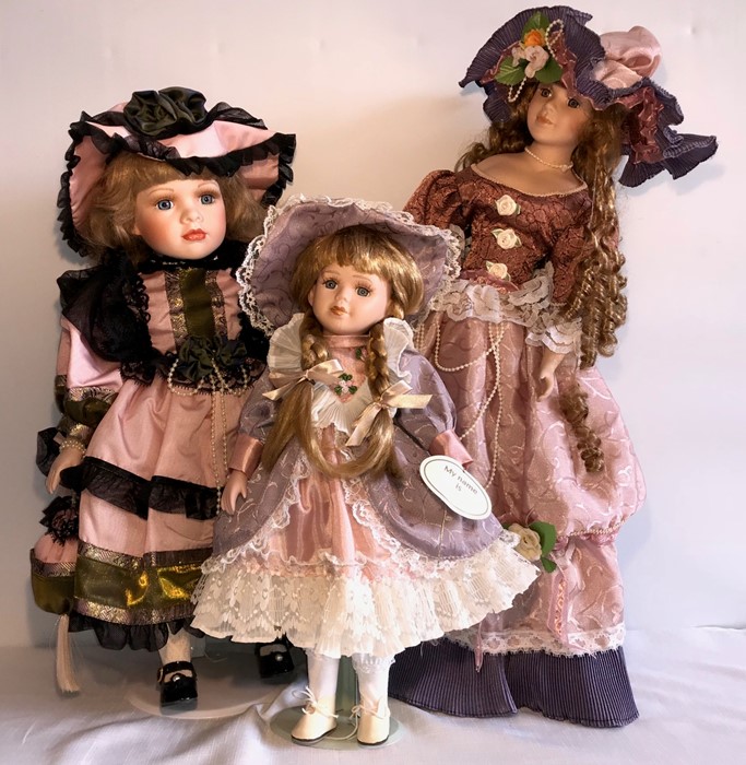 Three good quality modern porcelain headed dolls. H - 58cms.