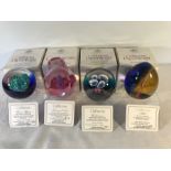 Caithness glass paperweights x 4 with stands.