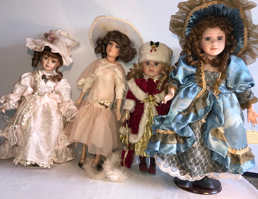 Four good quality modern porcelain headed dolls - 55cms.