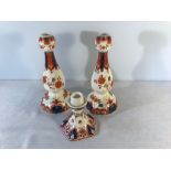 Pair of Delft tall candlesticks, 23.5cms h and a a smaller candlestick, 11.5cms h.