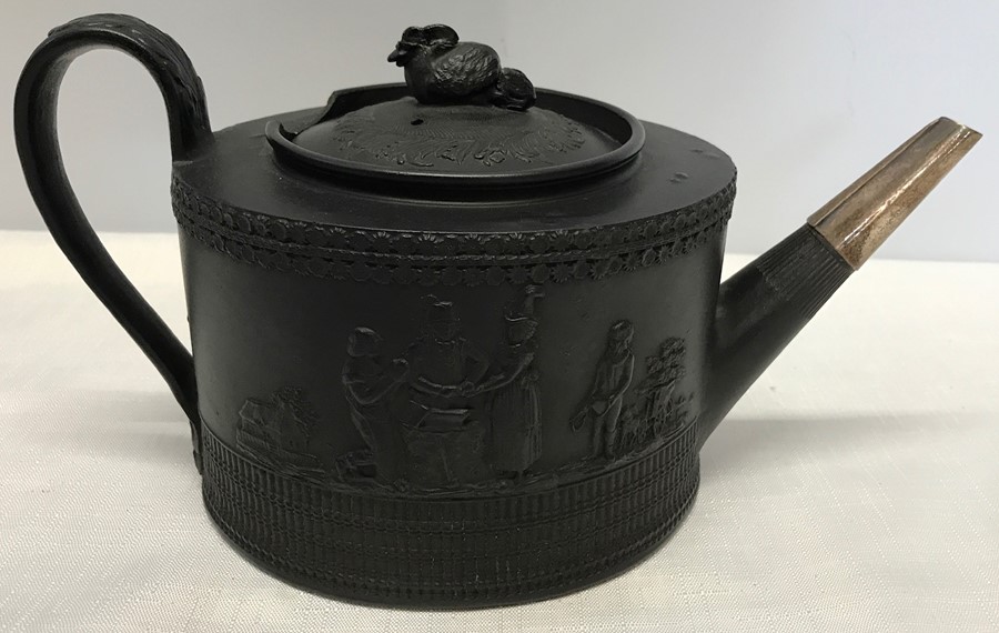 Black basalt teapot, design of runaway couple at Gretna Green, damage to rim top. 25cms w-13.5cms