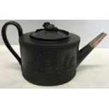 Black basalt teapot, design of runaway couple at Gretna Green, damage to rim top. 25cms w-13.5cms