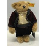 Steiff ring teddy bear, No 0155/23 dressed in Red Velvet top, brown trousers, 23cms tall.
