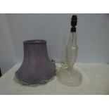 A cut glass table lamp, 38cms t with purple lampshade, minor chip to base.
