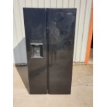 A black Grundig double fridge freezer. 180cms h x 91cms x 68cms.
