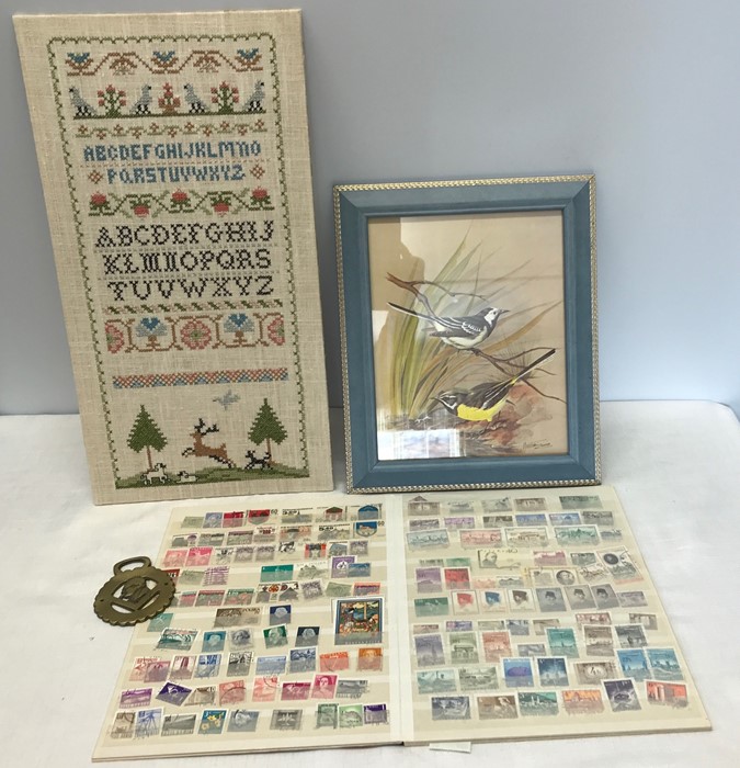 Needlework sampler, framed print of birds, World and British stamp album and Winston a Churchill