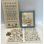 Needlework sampler, framed print of birds, World and British stamp album and Winston a Churchill