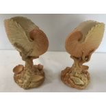 A pair of Royal Worcester shell vases, the main shell mounted on a coral stem above seashells,