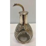 An early 20thC clear glass and Hong Kong Sterling silver oil or vinegar bottle. The silver overlay