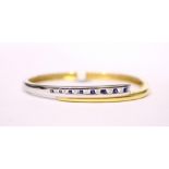AN 18CT YELLOW & WHITE GOLD BANGLE set with sapphires & diamonds, cased