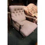 A LOW RISE BUTTON BACKED ARM CHAIR