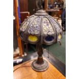 A BRONZED TIFFANY STYLE STAINED GLASS LAMP with pull chain and single bulb