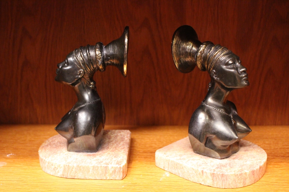 A PAIR OF ART DECO STYLE 'AFRICANIST' BOOKENDS, with two female figures of cast Spelter on pink