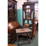 AN OAK HALL STAND, with dark stained oak, having a bevelled mirror and cabinet box with floral and