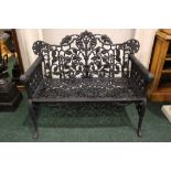 A CAST IRON GARDEN CHAIR, with rams head arm rests, foliage design to the back, 43" x 34" x 19"