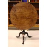 AN EARLY 19TH CENTURY TIP UP CENTRE TABLE, with circular top, on a birdcage support, over turned