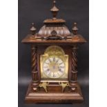 A LATE 19TH / EARLY 20TH CENTURY ENGLISH MANTLE CLOCK, oak cased, surmounted with turned & carved