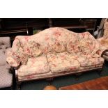 A FOUR SEATER COUCH, with floral upholstery & cushions