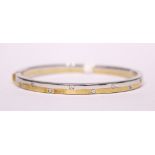 A 9CT YELLOW & WHITE GOLD BANGLE SET WITH DIAMONDS, cased