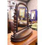 A MAHOGANY "SWING" DRESSING MIRROR, table top, with turned upright supports and demi lune platform