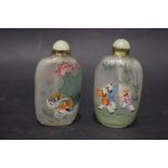 A PAIR OF 'PEKING' STYLE GLASS SNUFF BOTTLES, reverse painted with scenes of children at play and