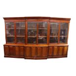 A VERY FINE MID 19TH CENTURY IRISH MAHOGANY BREAKFRONT LIBRARY BOOKCASE, with original glazed doors,