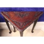 A CARVED OAK SIDE TABLE / OCCASIONAL TABLE, with triangular drop leaf, having carved floral design