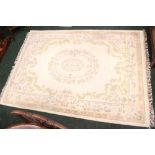 A FLOOR RUG, cream main colour, with floral design, 97" x 68" approx