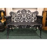 A CAST IRON GARDEN CHAIR, with rams head arm rests, foliage design to the back, 43" x 34" x 19"