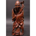 A HARDWOOD CARVING OF A SCHOLAR, holding a scroll in his hands, 7" tall approx