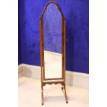 A MAHOGANY & WALNUT CHEVAL MIRROR, with shaped frame held on a pair of uprights with turned finial