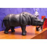 A LEATHER ORNAMENT / MODEL OF A RHINO, with glass eyes, 21" x 10" x 6" approx