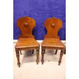 A PAIR OF SHIELD BACK HALL CHAIRS, with turned tapering front legs, sabre back, 34" x 16" x 15"