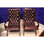 A PAIR OF BUTTON BACKED LEATHER ARM CHAIRS, with scroll shaped padded arm rests, beaded detail to